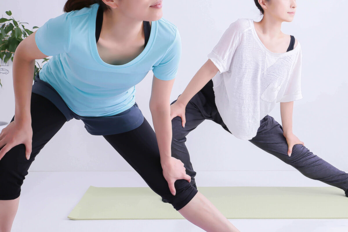 ストレッチで足を伸ばす人